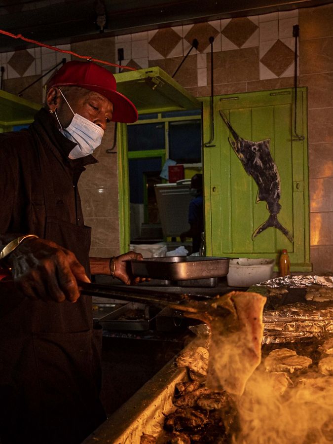 Photo of flames coming off a grill for cooking fish.