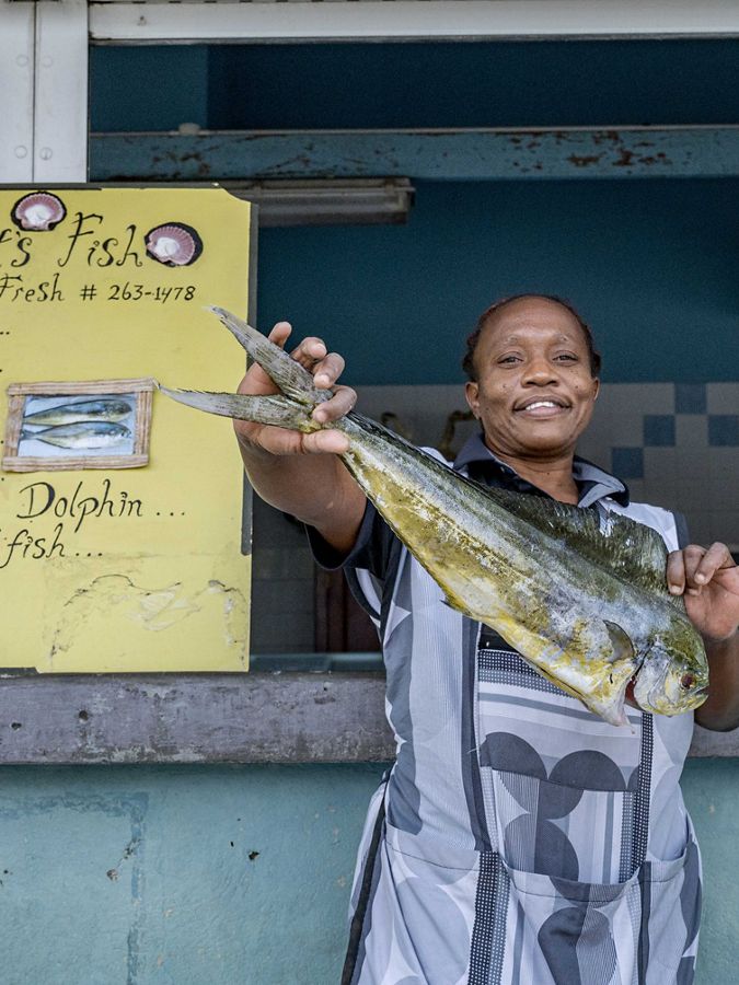 Photo of a woman named Natalie standing by a menu.