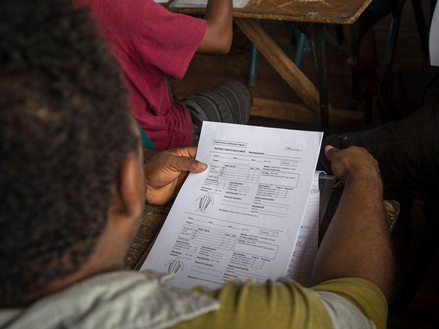 Potential rangers examine a data collection sheet at the training. 