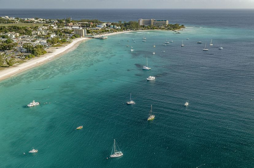an aerial image of a bay, speckled with boats.