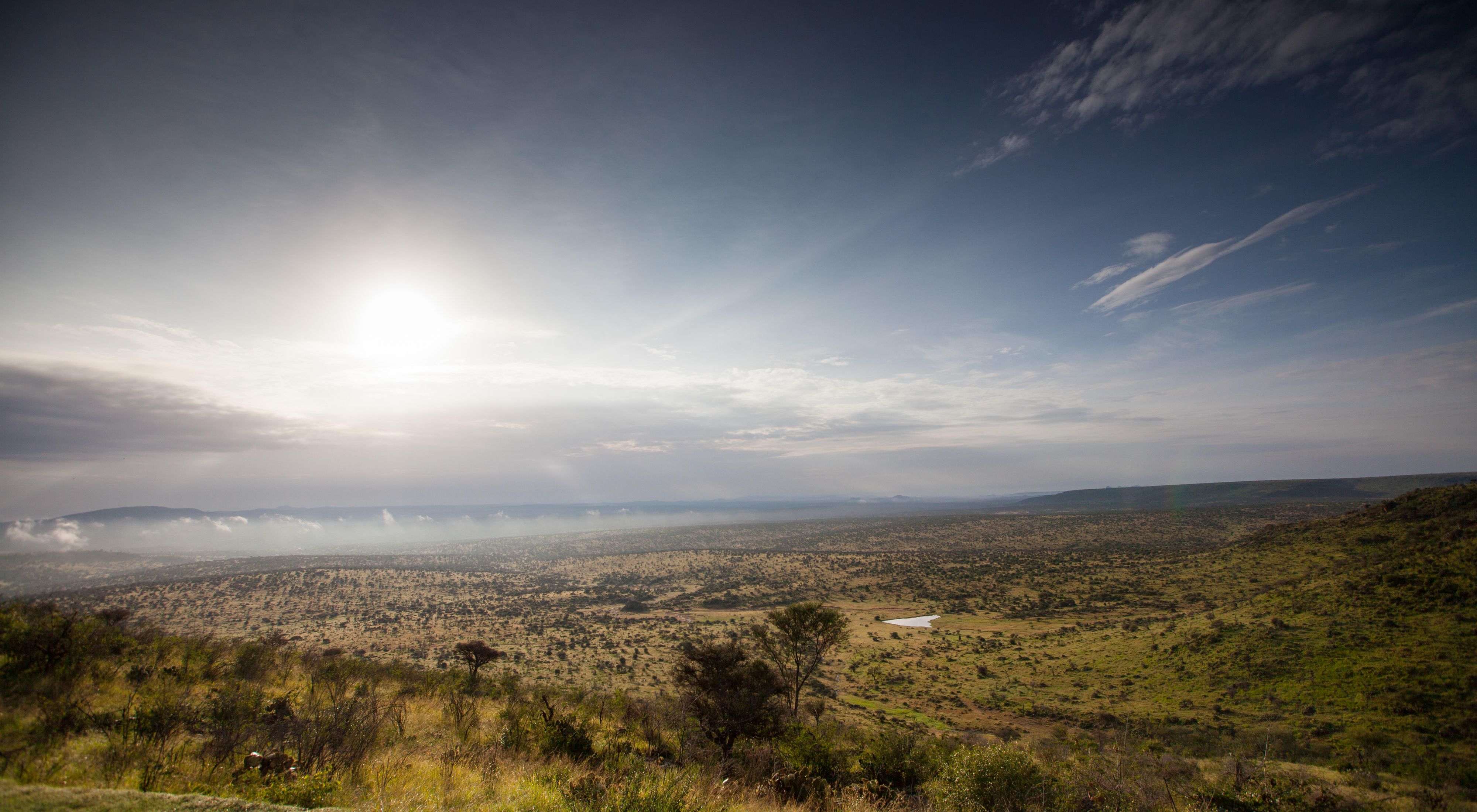 A colorfully dressed Samburu woman collecting water at West Gate Conservancy in northern Kenya. 