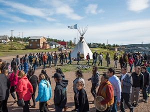 people stand in a circle around a fire in the northwest territories of canada