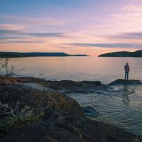 Ethan Rombough stands on a small island overlooking Christie Bay at the entry point of Thaidene Nëné National Park.