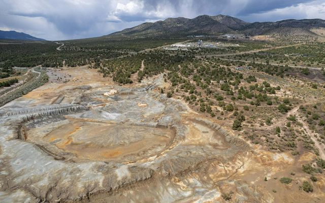 Disturbed mine lands in Nevada surrounded by desert and mountain landscape. 