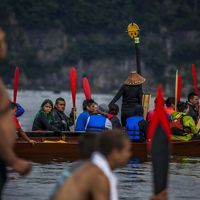 Families from around the Pacific Northwest gather in canoes to travel to Point Grenville on the Quinalt Reservation.